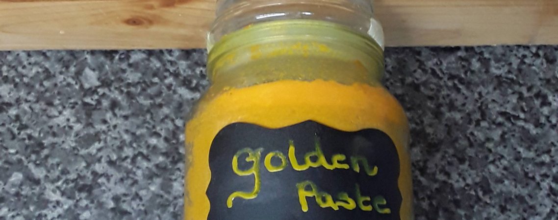 Jar of golden paste for curcumin benefits
