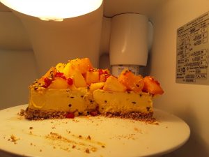 Tropical cheesecake with slices taken out of it