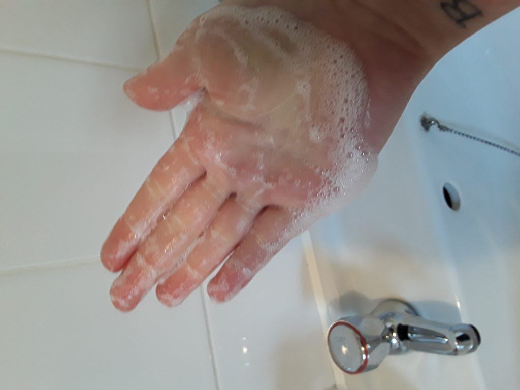 Natural skincare soup foam on a hand
